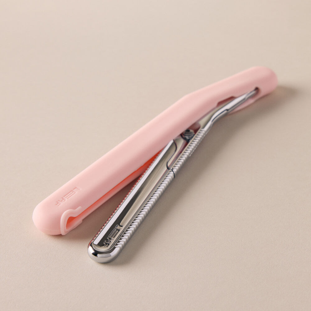 Dermaplaner coming out of a pink cover