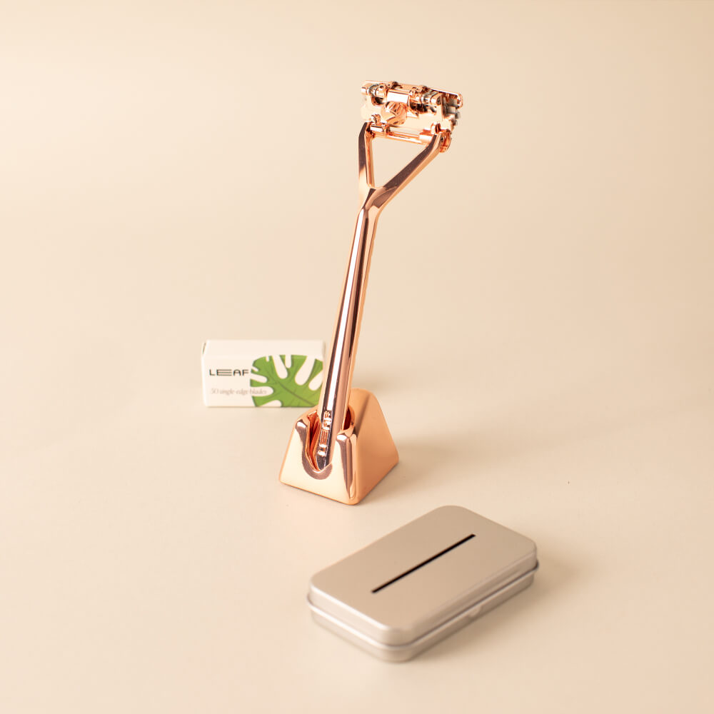 The rose gold Leaf razor kit with the razor, stand, package of blades, and recyclable tin